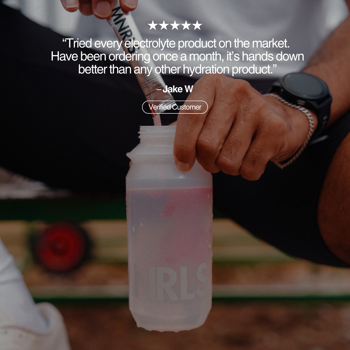 MNRLS Berry Cherry electrolyte drink being mixed in a bottle with five star customer review