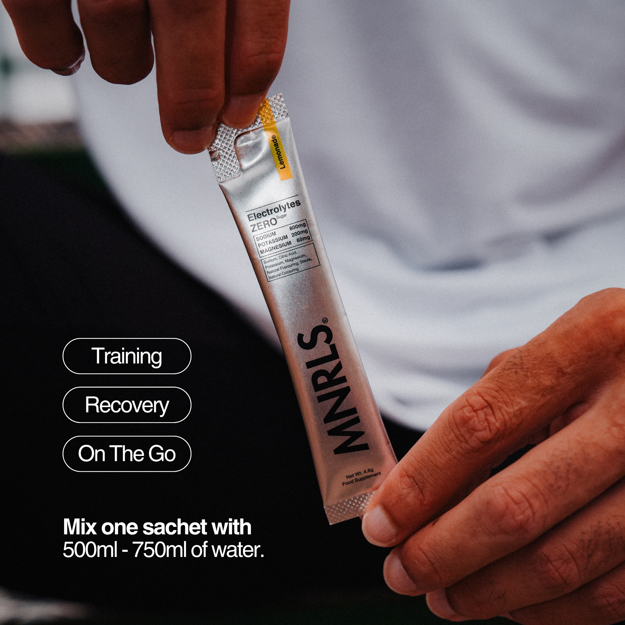 MNRLS Electrolytes Zero Lemonade sachet held by hand before mixing with water